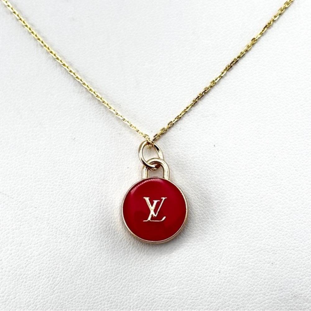 Repurposed necklace with Louis Vuitton round red zipper pull.